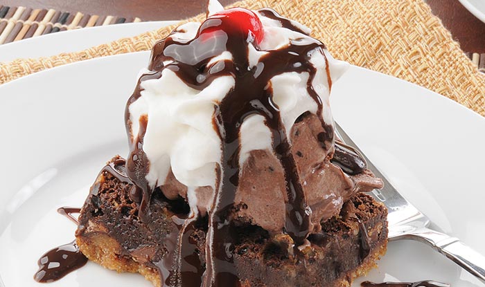 Indulge in a Sports Bar classic: brownie with chocolate ice cream, whipped cream, and a cherry.