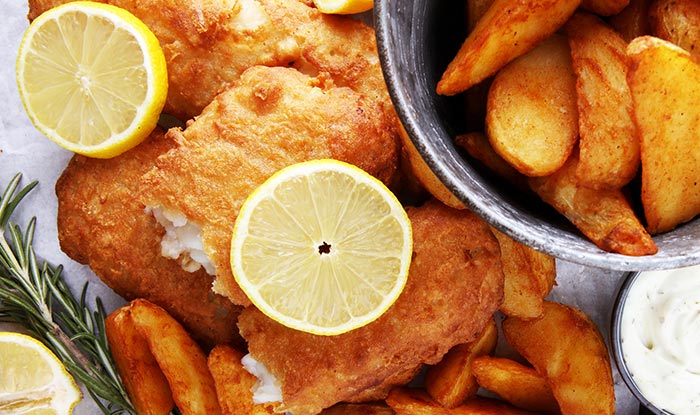 Golden fried fish at Tavern, with lemon, wedges, rosemary, and dipping sauce in Spring Grove.