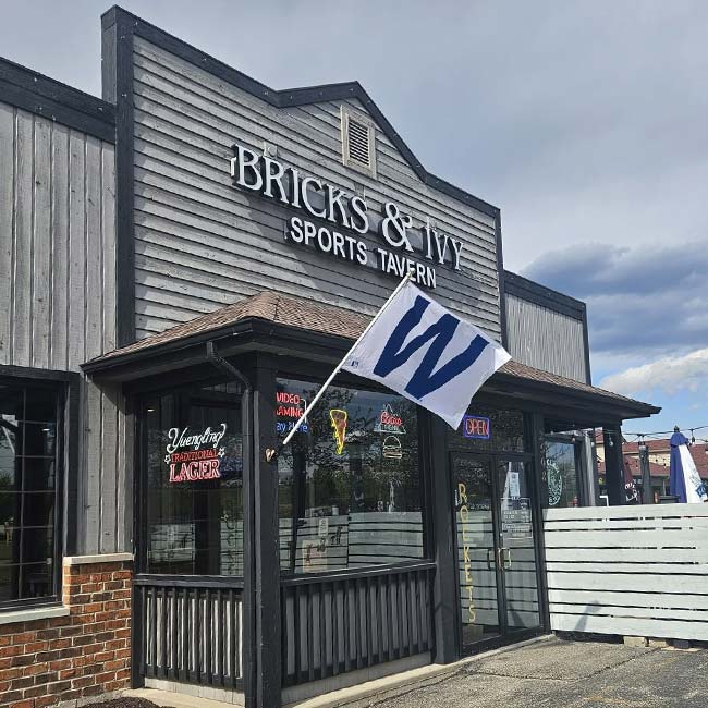 Bricks & Ivy Sports Bar and Restaurant with a white flag bearing a large blue W on the front.