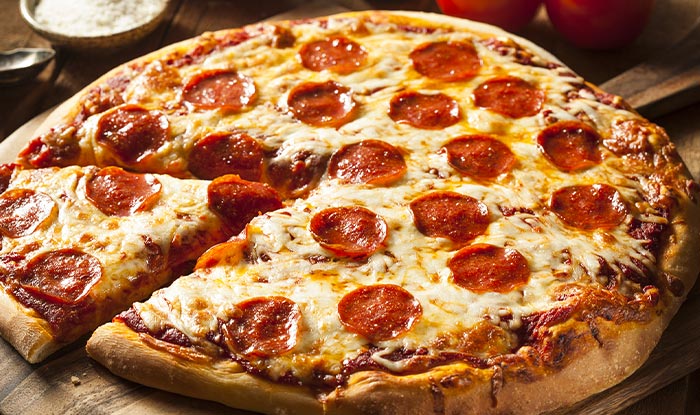 A pepperoni pizza from Bricks & Ivy in Spring Grove, with one cheesy slice pulled away.