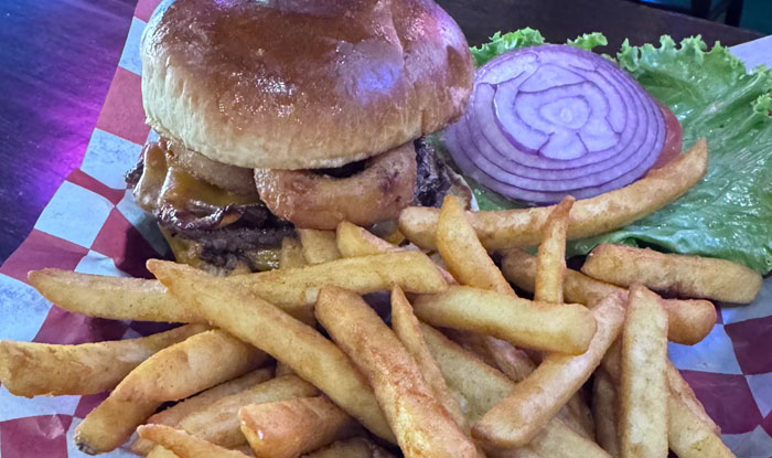 Cheeseburger with onion rings, lettuce, red onion, and fries on our Food Menu Spring Grove IL.